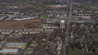 AX0166_0029 - 4K aerial stock footage of approaching apartment buildings and water tower in Palatine, Illinois