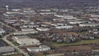 AX0166_0033 - 4K aerial stock footage of flying by warehouse buildings in Lake Zurich, Illinois