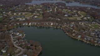 AX0166_0035 - 4K aerial stock footage of flying over upscale homes between lakes in Mundelein, Illinois