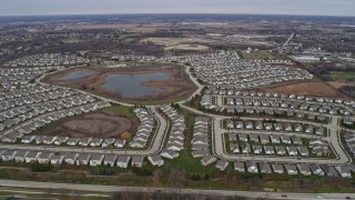 AX0166_0036 - 4K aerial stock footage of flying over tract homes in Mundelein, Illinois