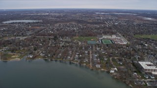 AX0166_0039 - 4K aerial stock footage of flying over lakeside homes and high school in Grayslake, Illinois