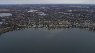 AX0166_0042 - 4K aerial stock footage of flying past lakeside homes in Lindenhurst, Illinois