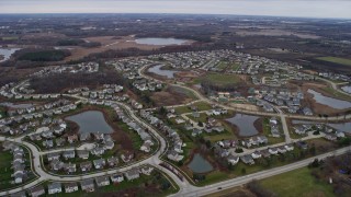 AX0166_0044 - 4K aerial stock footage of tract homes around small lakes in Antioch, Illinois