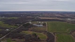 AX0166_0049 - 4K aerial stock footage of flying over farms and fields in Bristol, Wisconsin