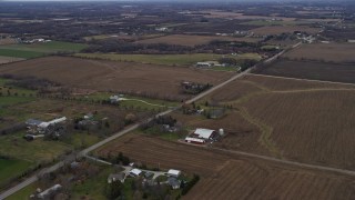 AX0166_0051 - 4K aerial stock footage of passing farms around a country road in Union Grove, Wisconsin