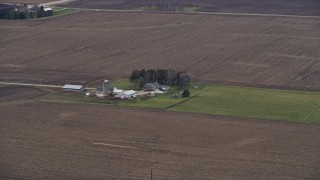 AX0166_0055 - 4K aerial stock footage of a barn, silo and farmhouse in Union Grove, Wisconsin