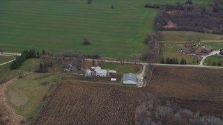 AX0166_0057 - 4K aerial stock footage of flying past farms and fields in Franksville, Wisconsin