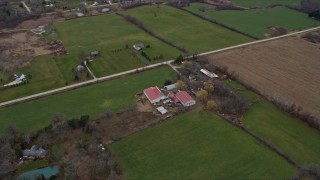 AX0166_0059 - 4K aerial stock footage of flying by barns in Franksville, Wisconsin