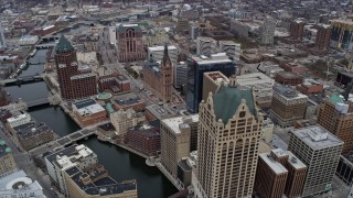 AX0166_0082 - 4K aerial stock footage of flying by office tower and city hall in Milwaukee, Wisconsin