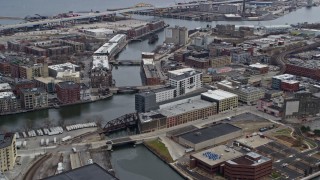AX0167_0027 - 4K aerial stock footage of riverfront office buildings by the Milwaukee River, Milwaukee, Wisconsin
