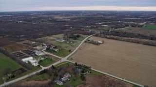 AX0167_0038 - 4K aerial stock footage of flying past farms and fields in Franksville, Wisconsin