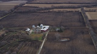 AX0167_0040 - 4K aerial stock footage of fields surrounding barns and silos in Franksville, Wisconsin