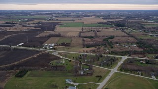 AX0167_0042 - 4K aerial stock footage of flying over fields and farms in Franksville, Wisconsin