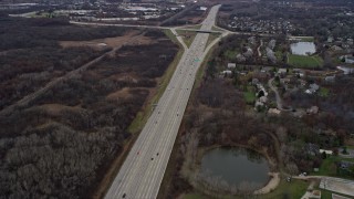 AX0167_0057 - 4K aerial stock footage of light traffic on the Tri-State Tollway freeway through Waukegan, Illinois