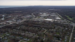 AX0167_0059 - 4K aerial stock footage of flying over homes near a car dealership, warehouse buildings and nature preserve in Lake Bluff, Illinois