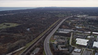 AX0167_0060 - 4K aerial stock footage of flying over highway toward a nature preserve in Lake Bluff, Illinois