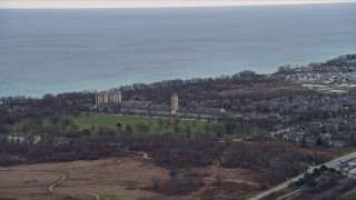 AX0167_0062 - 4K aerial stock footage of Fort Sheridan Water Tower and homes in Highland Park, Illinois