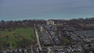 AX0167_0063 - 4K aerial stock footage of flying by Fort Sheridan Water Tower and homes in Highland Park, Illinois