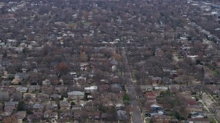 AX0167_0072 - 4K aerial stock footage of flying past suburban residential neighborhoods in Skokie, Illinois