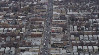 AX0167_0076 - 4K aerial stock footage of a busy street by urban neighborhoods in Northwest Side Chicago, Illinois
