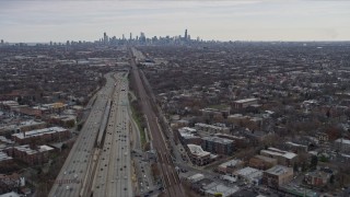 AX0167_0077 - 4K aerial stock footage of tilting from light freeway traffic to reveal wide view of Downtown Chicago skyline, Illinois