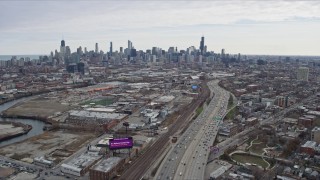 AX0167_0082 - 4K aerial stock footage of following light freeway traffic and the river toward the Downtown Chicago skyline, Chicago, Illinois