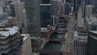 AX0167_0086 - 4K aerial stock footage of flying by skyscraper under construction to reveal the Chicago River in Downtown Chicago, Illinois
