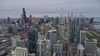 AX0167_0091 - 4K aerial stock footage of flying past skyscrapers and city buildings, reveal Grant Park in Downtown Chicago, Illinois