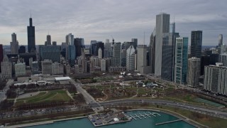 AX0167_0108 - 4K aerial stock footage approach the city's waterfront skyline and Grant Park from Lake Michigan, Downtown Chicago, Illinois