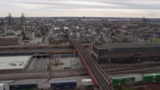 AX0168_0001 - 4K aerial stock footage ascend over train tracks to reveal urban neighborhood, West Side Chicago, Illinois