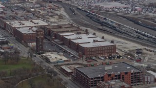AX0168_0006 - 4K aerial stock footage of flying past factory buildings on the Southwest Side Chicago, Illinois