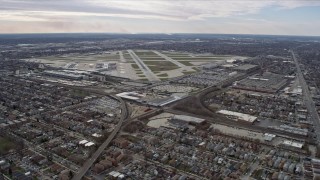 AX0168_0010 - 4K aerial stock footage approaching the runways and commercial planes at terminals at Chicago Midway International Airport, Illinois