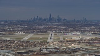 AX0168_0015 - 4K aerial stock footage of the Downtown Chicago skyline and Chicago Midway International Airport, Illinois