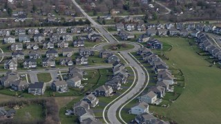 AX0168_0026 - 4K aerial stock footage of a reverse view of tract homes in a suburban neighborhood in Lemont, Illinois