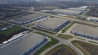 AX0168_0027 - 4K aerial stock footage approach and fly over warehouse buildings in Lockport, Illinois