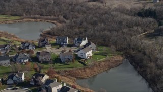 AX0168_0031 - 4K aerial stock footage of flying away from waterfront homes in Lockport, Illinois