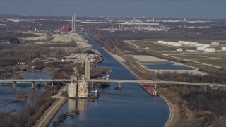 AX0168_0032 - 4K aerial stock footage of a bridge spanning a shipping canal in Lockport, Illinois
