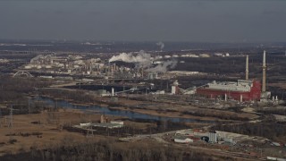 AX0169_0001 - 4K aerial stock footage of flying by an oil refinery and power plant in Romeoville, Illinois
