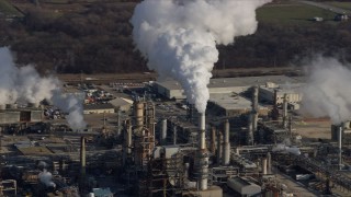 AX0169_0003 - 4K aerial stock footage of plumes of steam rising from an oil refinery in Romeoville, Illinois