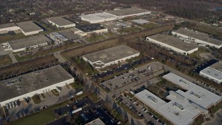 AX0169_0004 - 4K aerial stock footage approach and fly over warehouse buildings in Woodridge, Illinois