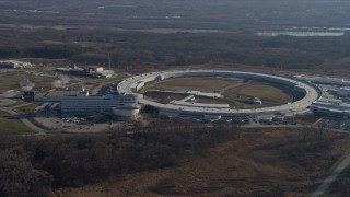 AX0169_0006 - 4K aerial stock footage of flying past the Advanced Photon Source at the Argonne National Laboratory in Lemont, Illinois