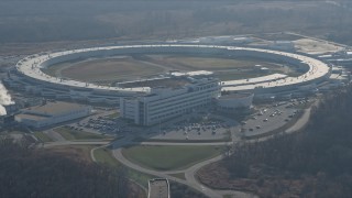 AX0169_0007 - 4K aerial stock footage of a reverse view of the Advanced Photon Source at the Argonne National Laboratory in Lemont, Illinois