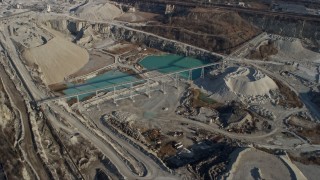 AX0169_0013 - 4K aerial stock footage of flying past ponds at a quarry in Hodgkins, Illinois