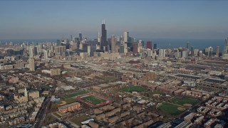 AX0169_0022 - 4K aerial stock footage tilt from West Side Chicago urban neighborhoods to reveal the Downtown Chicago skyline, Illinois