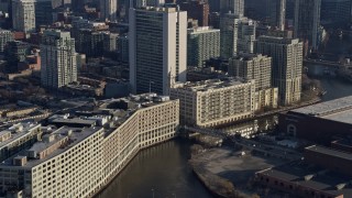 AX0169_0026 - 4K aerial stock footage of the Chicago River between office buildings in Downtown Chicago, Illinois