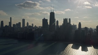 AX0169_0031 - 4K aerial stock footage tilt from Lake Michigan to reveal John Hancock Center and skyscrapers, Downtown Chicago, Illinois