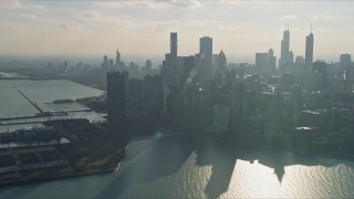 AX0169_0033 - 4K aerial stock footage of passing by the city's downtown skyscrapers, reveal Navy Pier, Downtown Chicago, Illinois