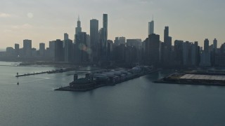 AX0169_0034 - 4K aerial stock footage of a reverse view of the city's downtown skyscrapers and Navy Pier, Downtown Chicago, Illinois