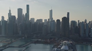 AX0169_0036 - 4K aerial stock footage tilt from lake to reveal Navy Pier and city's downtown skyline, Downtown Chicago, Illinois