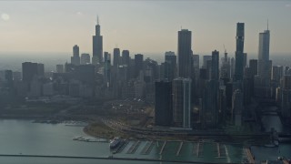 AX0169_0037 - 4K aerial stock footage of flying past waterfront skyscrapers and Grant Park, Downtown Chicago, Illinois